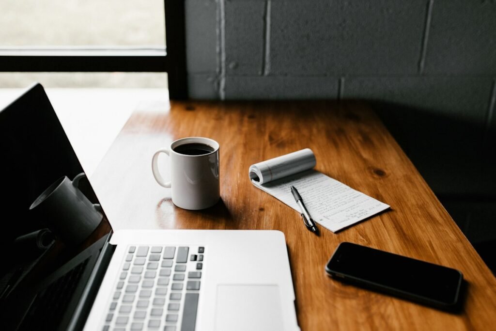 Laptop and coffee on a desk representing the blog